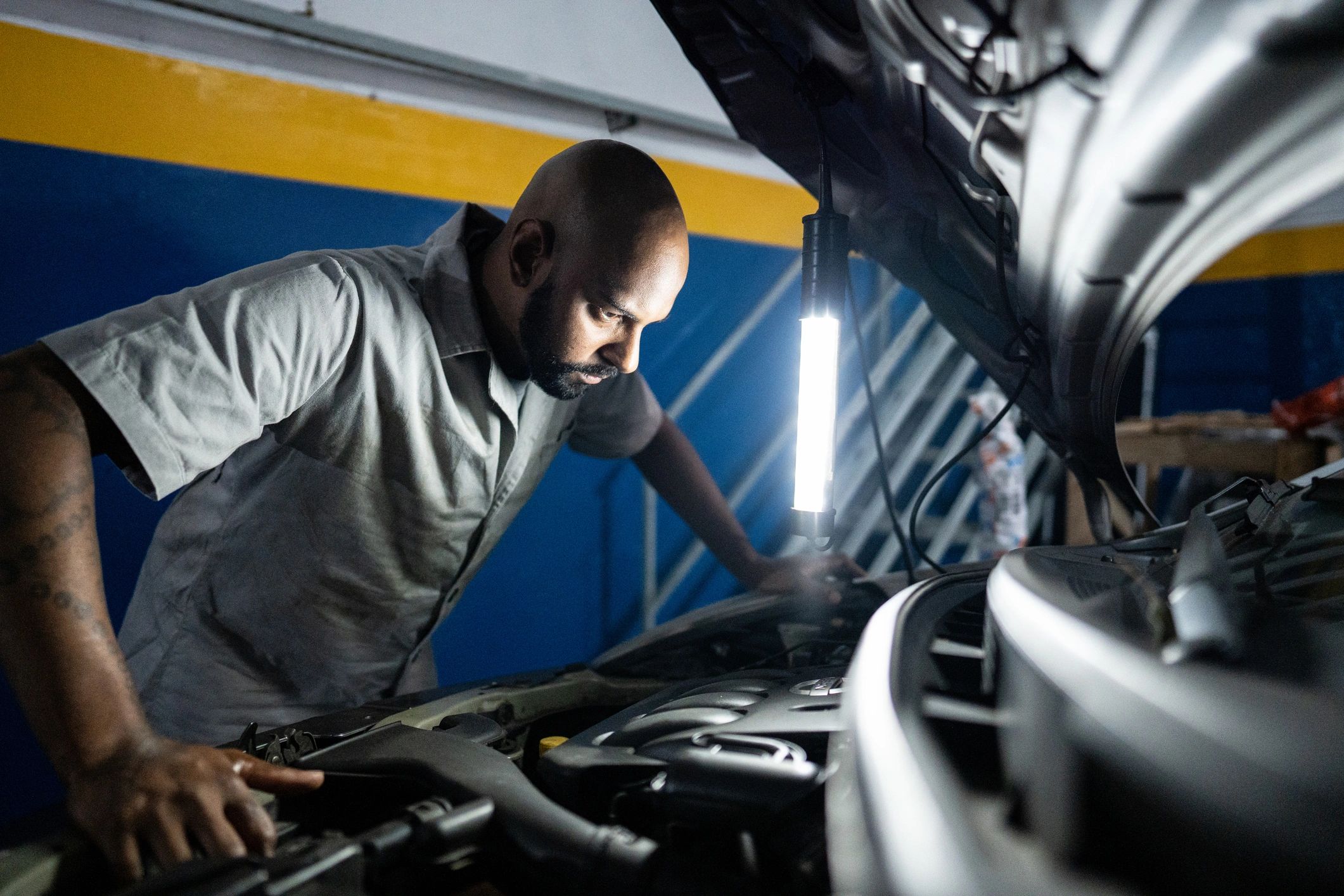 Mechanic working on a vehicle in an auto repair shop
