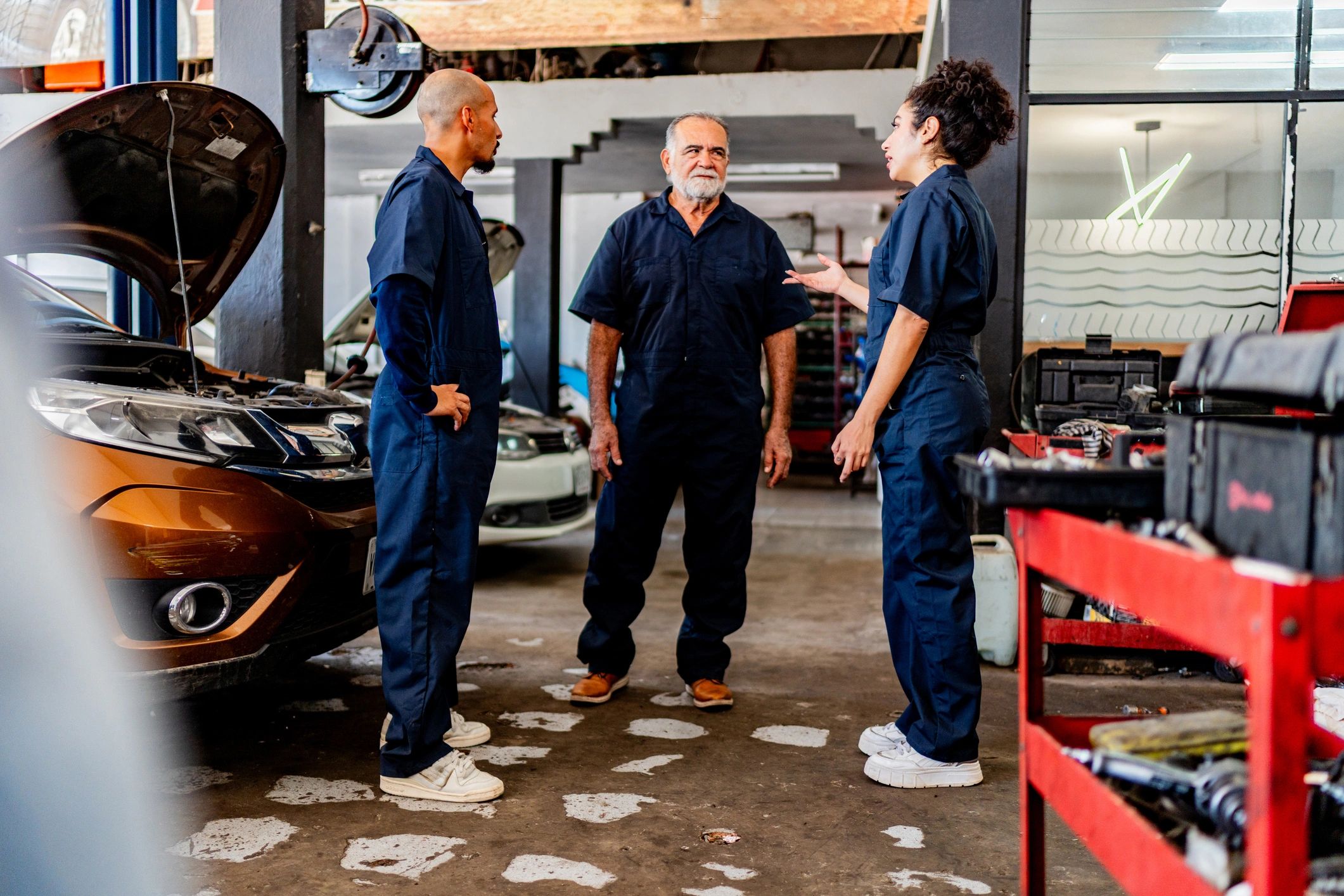 Auto technicians discussing a repair plan in the shop
